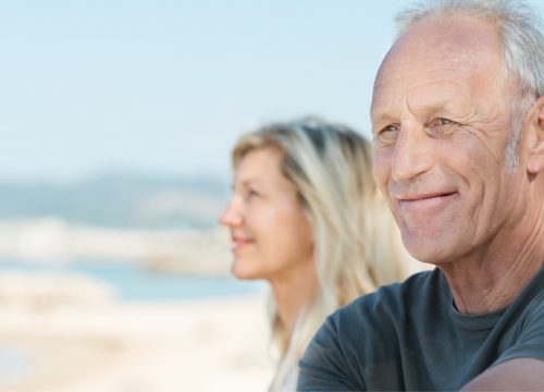 Older man with high cholesterol at the beach with his wife