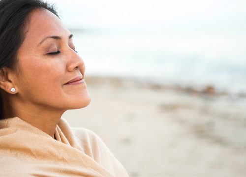 Woman looking refreshed at the beach after TempSure Vitalia