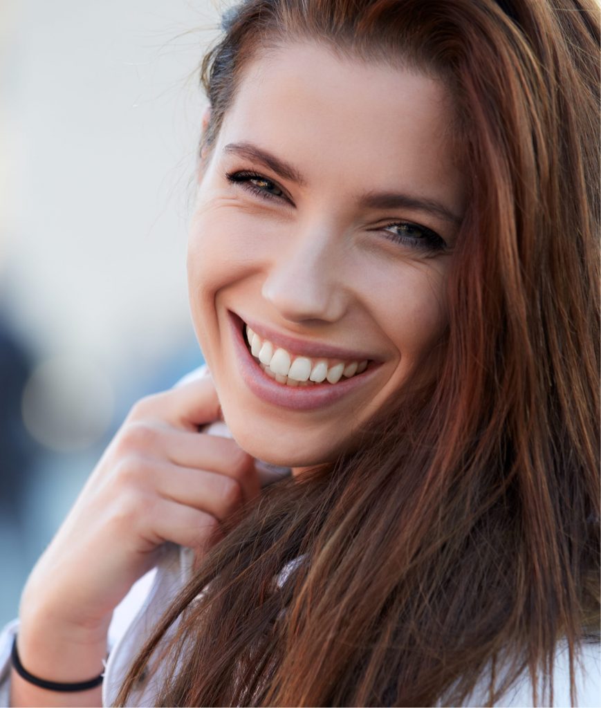 woman smiling after her GiGi Signature Facial